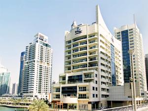 a group of tall buildings in a city at Full sea view with balcony with 5 stars hotel exceptional entertainment - Studio Apartment - 10 min to JBR - in Dubai