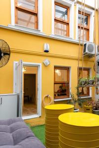 a yellow building with a yellow table and chairs at La Villa Gardenia : 4Br Villa with Private Garden in Istanbul