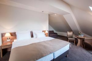Łóżko lub łóżka w pokoju w obiekcie Hotel Gem
