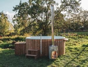 a hot tub in the grass in a field at The Valley x Wilsum in Wilsum