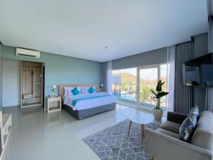 a bedroom with a bed and a living room at Zasgo Hotel in Labuan Bajo