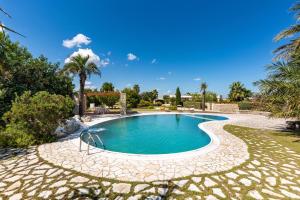 a swimming pool with a stone path around it at Villa del Sol by Perle di Puglia in Otranto