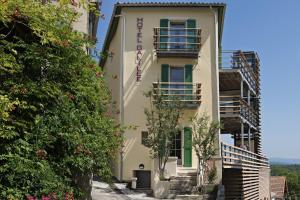 a building with balconies and flowers at Hotel Galilee in Saint-Michel-lʼObservatoire