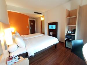 Voodi või voodid majutusasutuse Swiss-Belinn Cawang toas