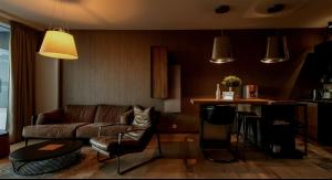 a living room with a couch and a bar at Magna Vita apartment in Bratislava