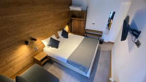 Postel nebo postele na pokoji v ubytování Hotel La Verticale