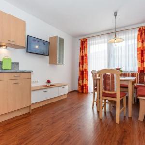 a kitchen and dining room with a table and chairs at Appartement Nr 6 Alpenstern in Wagrain