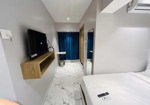 a room with a bed and a tv on a wall at Grand Dyad Hotel - Near Kokilaben Hospital Andheri West in Mumbai