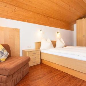 a bedroom with two beds and a couch in it at Appartement Nr 6 Alpenstern in Wagrain