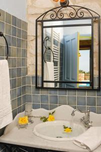 a bathroom with a sink and a mirror at Villa Lida Aresti in Agios Leon