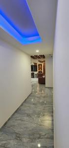 a hallway with a blue ceiling in a room at Hotel Sun Shine in Ahmedabad