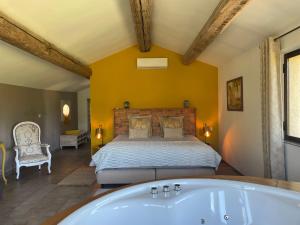 a bedroom with a bed and a bath tub at Côté Dentelles in Vacqueyras +107 photos