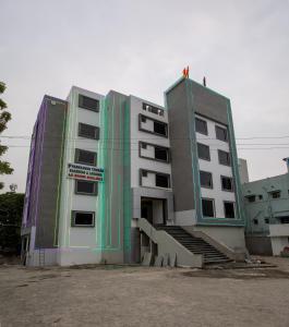 a building with a person standing on top of it at PARKKAVAN TOWERS in Tiruchchirāppalli