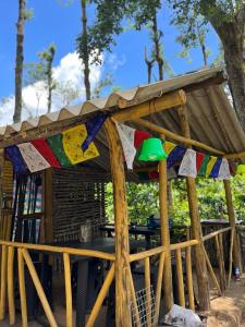 um abrigo de madeira com uma mesa e bandeiras em antelopewildstay em Kutta