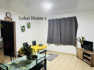 a living room with a table and a tv at Lokai house in Bora Bora