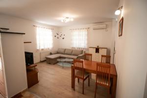 a living room with a table and a couch at Apartment Gracia 1 in Baška
