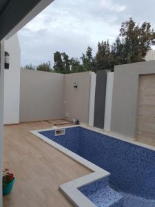 a swimming pool in the middle of a house at Comfystay in Hammamet