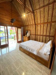 - une chambre avec un lit dans une pièce en bois dans l'établissement Kintamani Blessing, à Kubupenlokan
