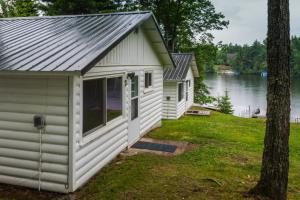 a small white building with a metal roof at Elemental Resort in Gwinn