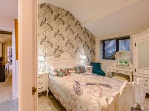 a bedroom with a large bed and a stone wall at 2 Bed in Pendle 91032 in Brierfield