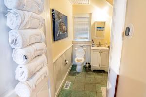 a bathroom with a stack of towels on a wall at Hit the Slopes! in Intervale