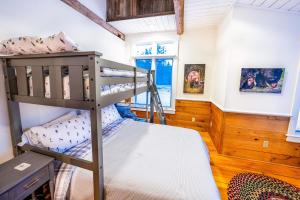 a bedroom with two bunk beds and a window at Hit the Slopes! in Intervale
