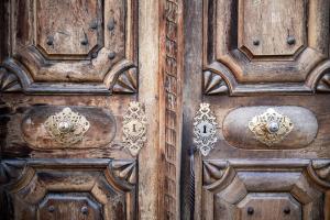 an old wooden door with intricate designs on it at Boutique Hotel Pachers in Bressanone