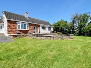 a brick house with a lawn in front of it at 3 Bed in Cockermouth 90920 in Tallentire