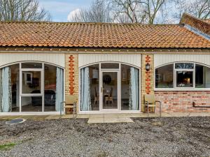 a house with glass doors and chairs in it at 2 Bed in Skendleby Psalter 91139 in Skendleby