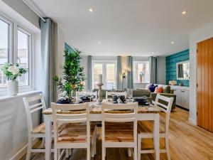 a dining room with a white table and chairs at 3 Bed in Lulworth Cove 91200 in West Lulworth