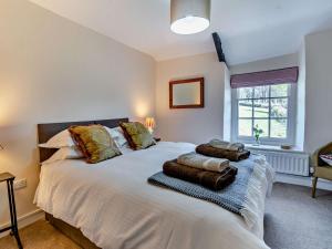 a bedroom with a white bed with pillows on it at 3 Bed in Llanover 91241 in Llanover