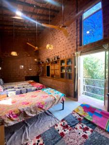 a room with two beds and a large window at Moradia dos Quadros in Divar