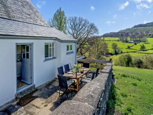 a table and chairs in front of a house at 3 Bed in Llanover 91241 in Llanover