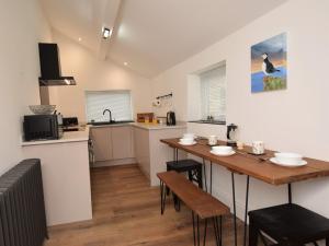 a kitchen and dining room with a table and chairs at 2 Bed in Amble 91206 in Amble
