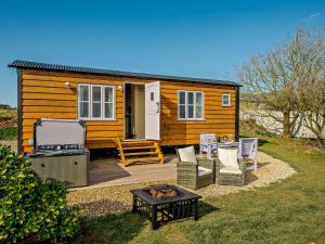 a tiny house with a deck and a grill at 1 Bed in Boscastle 90818 in Camelford