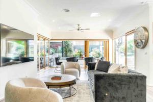 a living room with a couch and a table at Luxury Holiday Rental On the Mornington Peninsula in Frankston South