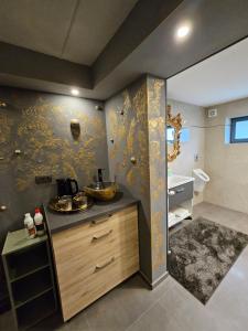 a bathroom with a counter with a sink in it at Apartments & wellness Kal Koritnica in Bovec