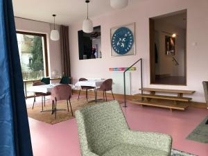 a living room with a table and chairs and a mirror at Lèvres Hotel in Schrobenhausen