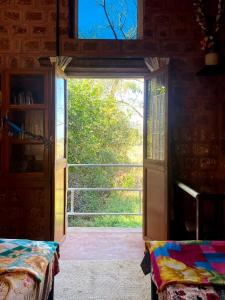 an open door to a room with a window at Moradia dos Quadros in Divar