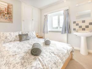 a bedroom with a bed and a sink at 3 Bed in Weare Giffard 90864 in Weare Giffard