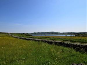 a road in a field next to a body of water at 1 Bed in Holmfirth 91106 in Cartworth