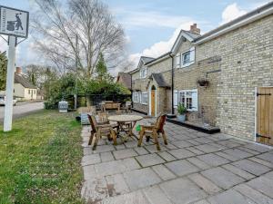 a patio with a table and chairs next to a building at 3 Bed in Skendleby 91142 in Skendleby