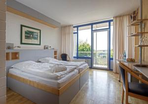 Postel nebo postele na pokoji v ubytování SeminarZentrum Rückersbach + 32 fotografií