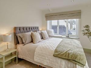 a bedroom with a large bed with a window at 3 Bed in Gilwern 91181 in Gilwern