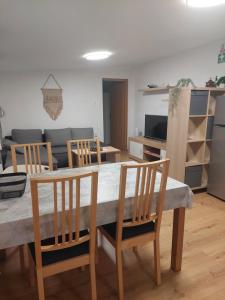 eine Küche und ein Esszimmer mit einem Tisch und Stühlen in der Unterkunft Apartman Ždralović in Lipik