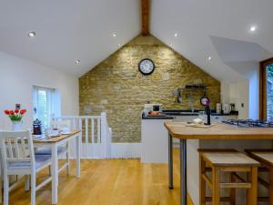 a kitchen and dining room with a brick wall at 1 Bed in Castle Cary 91185 in Castle Cary