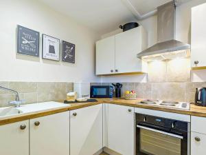 a kitchen with white cabinets and a sink at 2 Bed in Skendleby 91141 in Skendleby