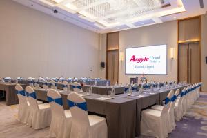 a conference room with a long table and chairs at Argyle Grand Hotel Nairobi Airport in Nairobi