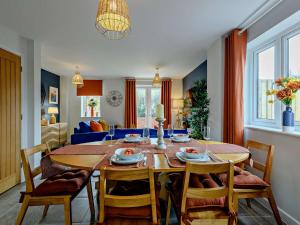 a dining room with a wooden table and chairs at 2 Bed in Lulworth Cove 91197 in West Lulworth