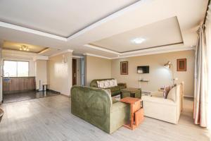 a living room with two chairs and a couch at Eldon Suites & Apartments By MOKAWA in Nairobi